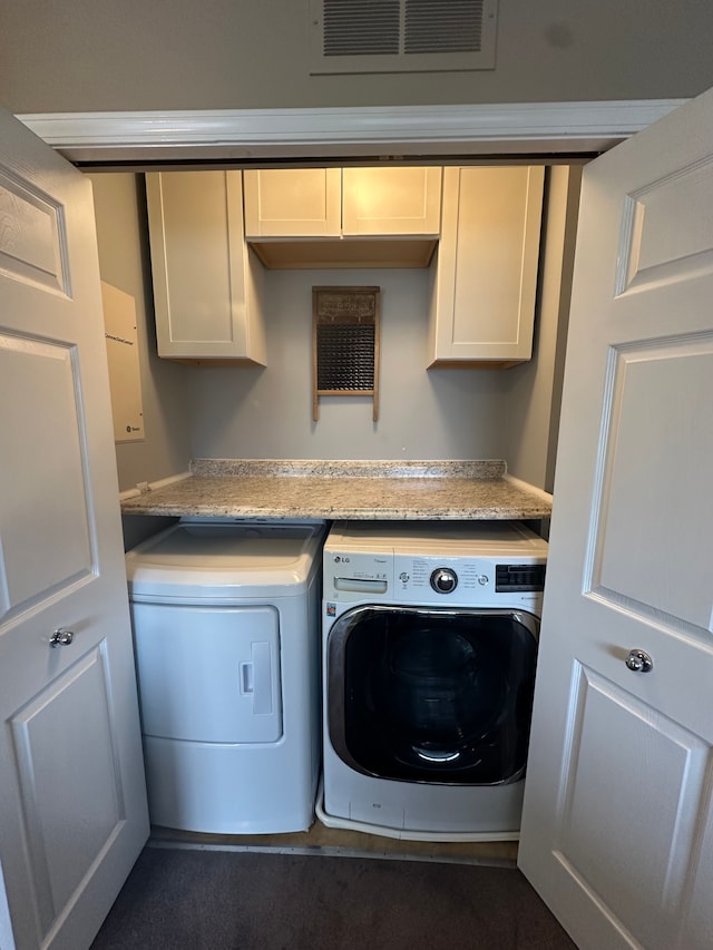 laundry room with independent washer and dryer and cabinets