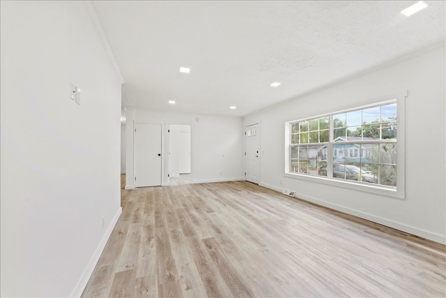 interior space featuring ornamental molding and light hardwood / wood-style flooring