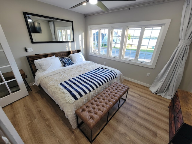 bedroom with ceiling fan and hardwood / wood-style floors