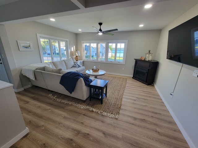 living room with ceiling fan and light wood-type flooring