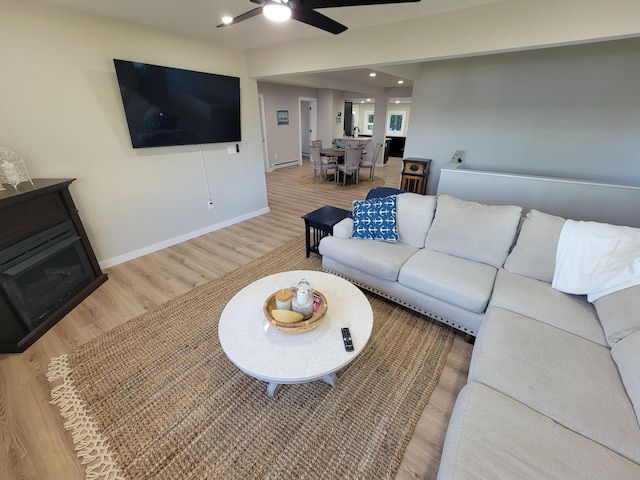 living room with hardwood / wood-style flooring and ceiling fan