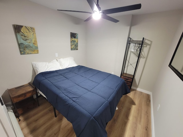 bedroom with hardwood / wood-style flooring and ceiling fan