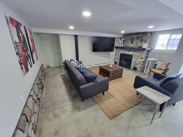 living room with a baseboard heating unit, a stone fireplace, and carpet floors