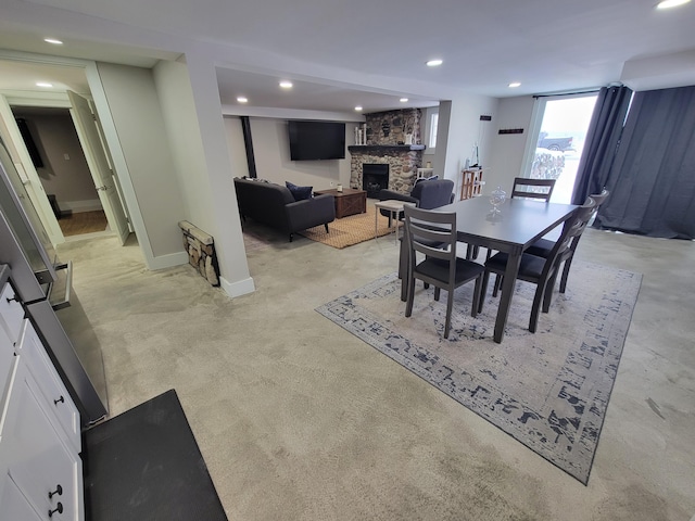 dining space with a stone fireplace