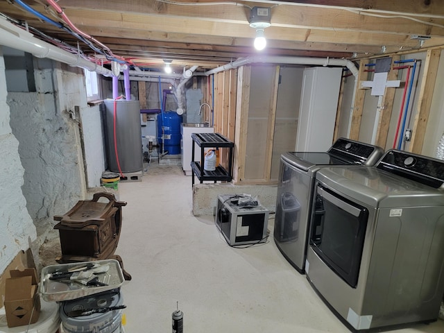 basement with washing machine and dryer and water heater