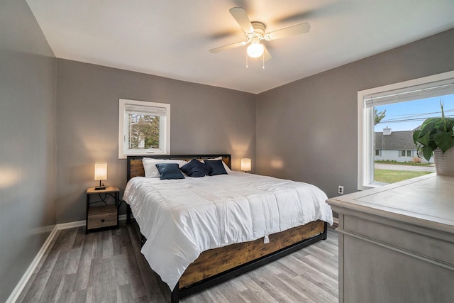 bedroom with hardwood / wood-style flooring and ceiling fan