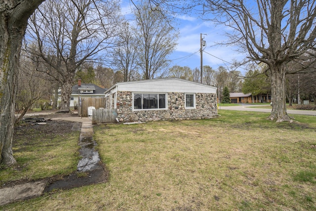 view of side of home with a lawn