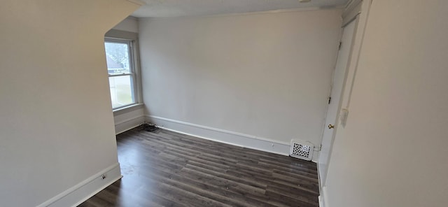 empty room with dark hardwood / wood-style floors