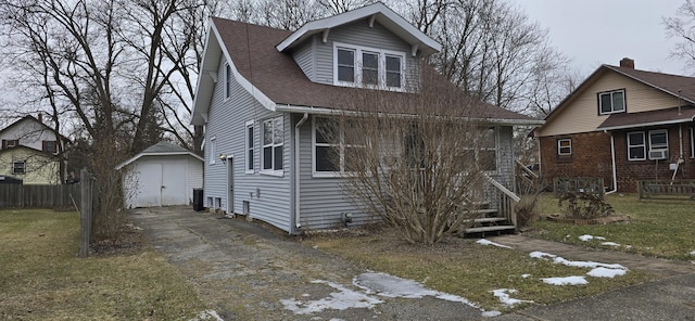 view of front facade featuring a shed, central AC unit, and a front lawn