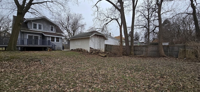 view of yard with a deck and a storage shed