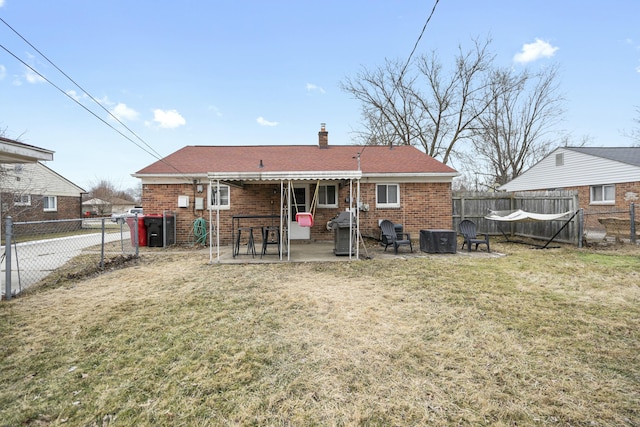 rear view of property with central AC, a patio, and a lawn