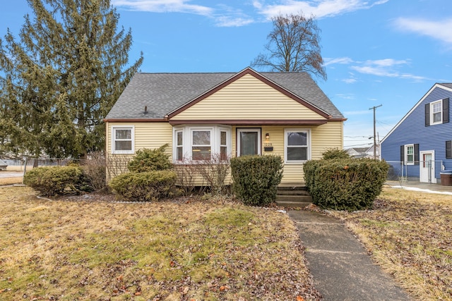 bungalow-style home with a front lawn