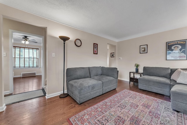 living room featuring hardwood / wood-style flooring and a textured ceiling