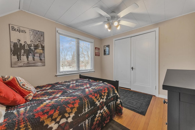 bedroom with hardwood / wood-style flooring, ceiling fan, and lofted ceiling