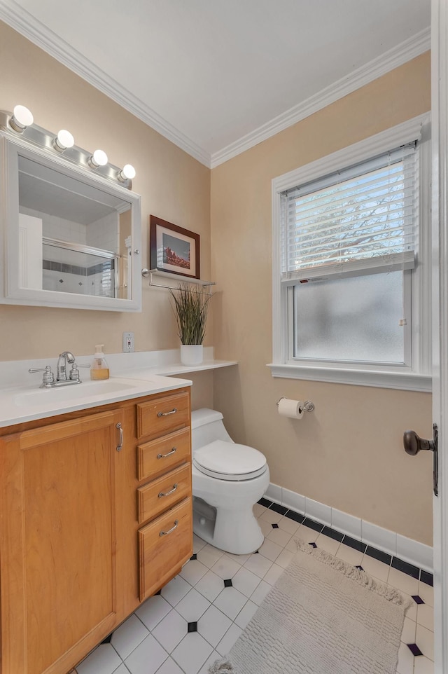 bathroom featuring crown molding, tile patterned floors, toilet, and vanity