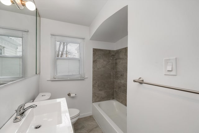 full bathroom with tile patterned floors, sink, toilet, and tiled shower / bath