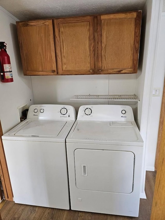 2054 Woodside Dr, Caro, MI 48723 - clothes washing area with cabinet space, washer and dryer, and wood finished floors