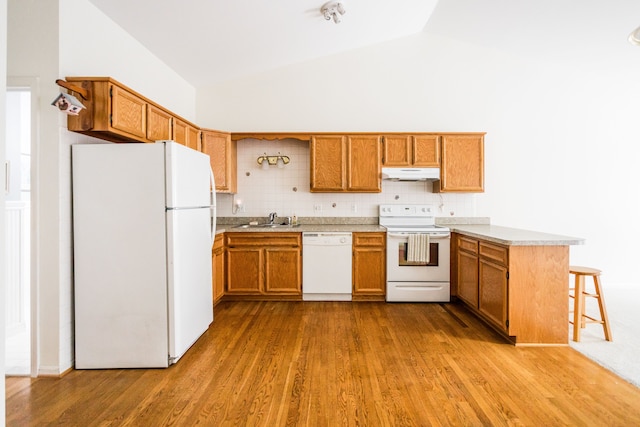 kitchen with sink, tasteful backsplash, kitchen peninsula, white appliances, and light hardwood / wood-style floors