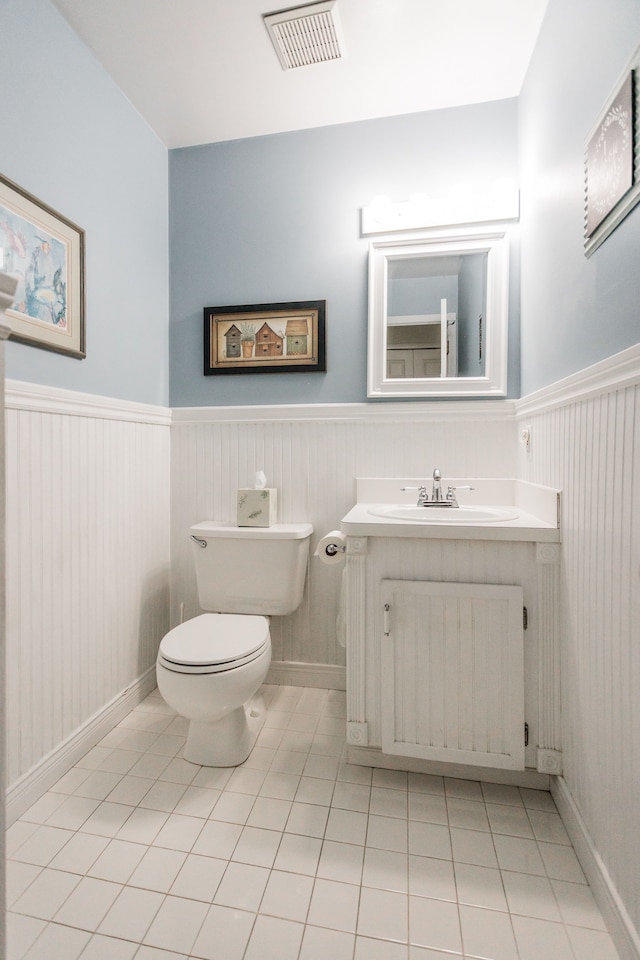 bathroom featuring tile patterned flooring, vanity, radiator heating unit, and toilet