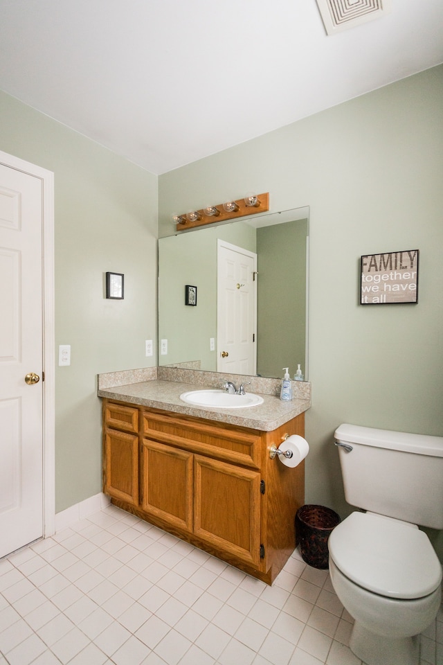 bathroom with tile patterned flooring, vanity, and toilet