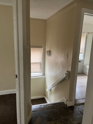 stairway featuring crown molding