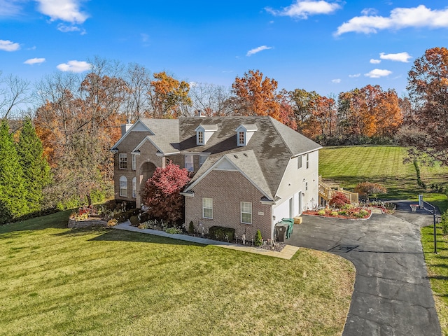 view of front of house with a garage and a front yard