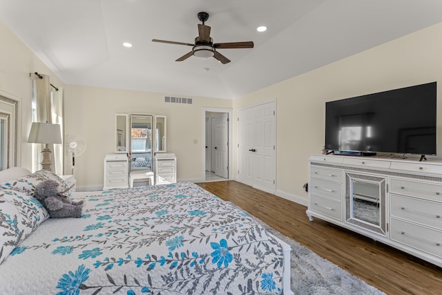 bedroom with vaulted ceiling, dark wood-type flooring, and ceiling fan