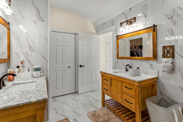 bathroom with vanity, vaulted ceiling, and tile walls