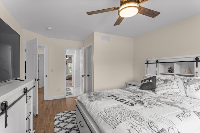 bedroom with ceiling fan and light hardwood / wood-style flooring