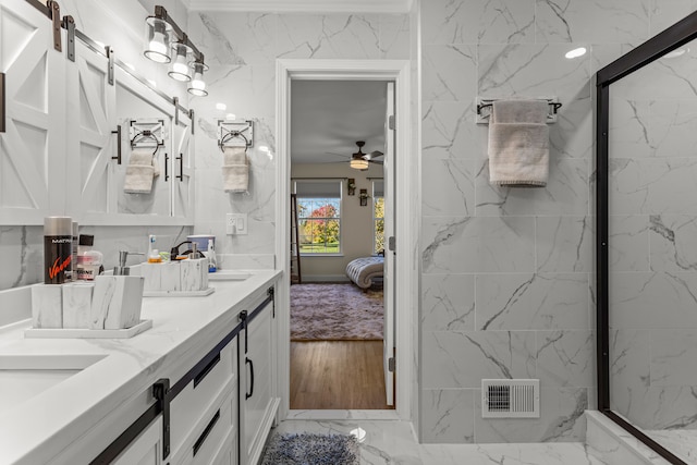 bathroom with vanity, ceiling fan, and a shower with shower door