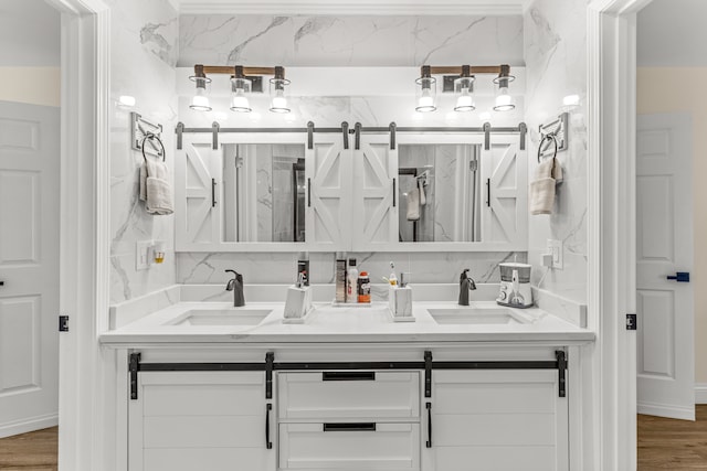 bathroom with vanity, hardwood / wood-style floors, and decorative backsplash