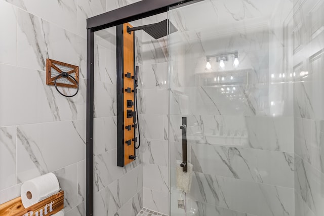 bathroom with a shower with door