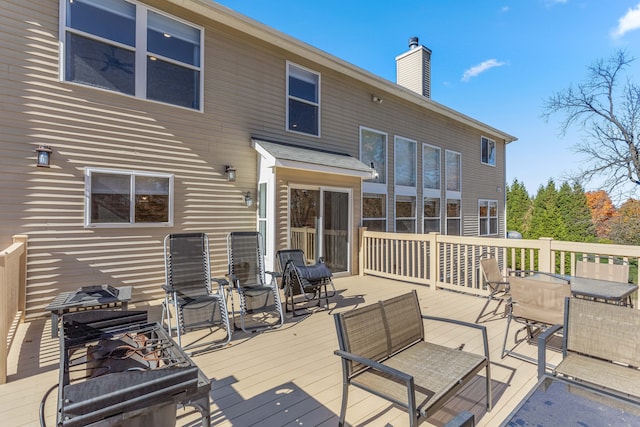 rear view of property with a wooden deck