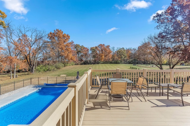 view of swimming pool featuring a yard and a deck