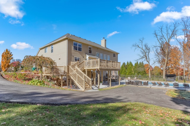 back of house featuring a patio and a pool side deck