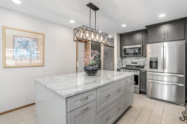 kitchen with gray cabinets, backsplash, hanging light fixtures, a center island, and stainless steel appliances