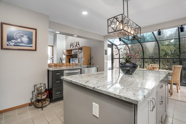 kitchen with light tile patterned flooring, sink, a center island, dishwasher, and pendant lighting