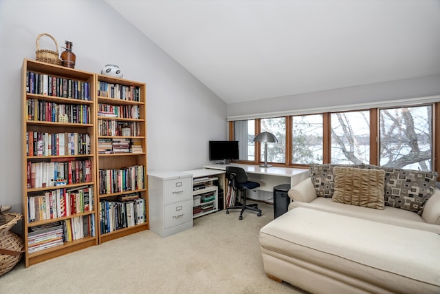 office space with lofted ceiling and light colored carpet