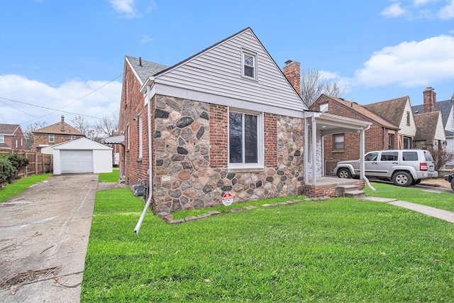 view of front of house with an outbuilding, a garage, and a front yard