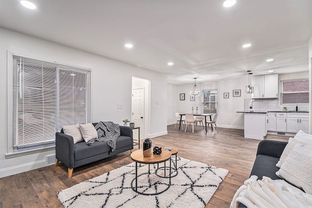 living room featuring dark hardwood / wood-style flooring and sink