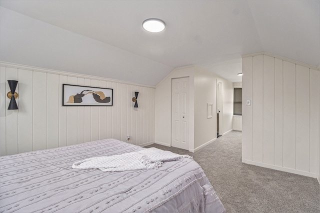 bedroom with carpet floors and vaulted ceiling