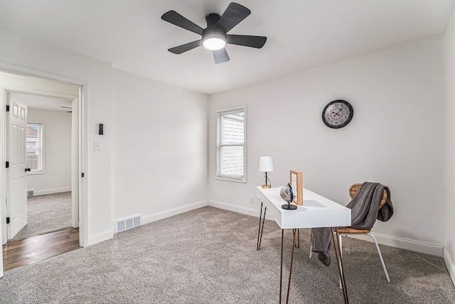 carpeted office with ceiling fan