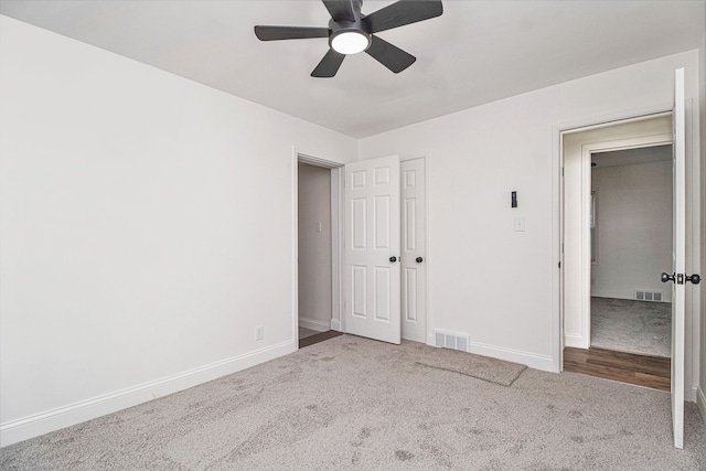 unfurnished bedroom with a closet, ceiling fan, and carpet