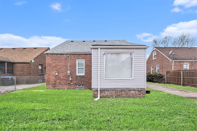 back of property featuring a yard