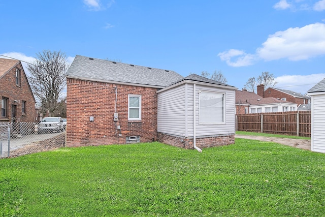 back of property featuring a yard