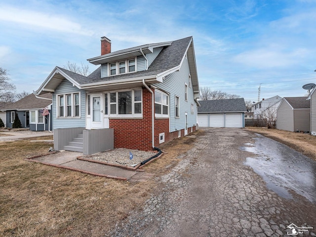 bungalow featuring an outbuilding and a garage