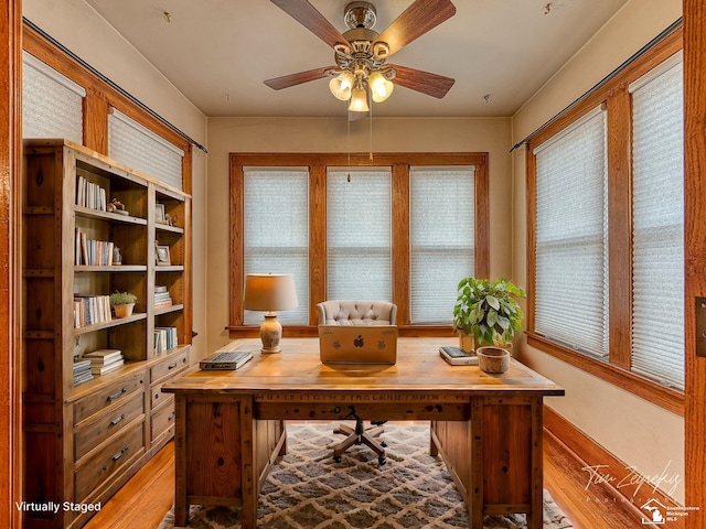 home office featuring ceiling fan and light hardwood / wood-style flooring