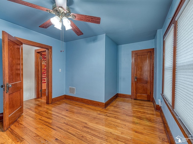 unfurnished bedroom with ceiling fan and light hardwood / wood-style flooring