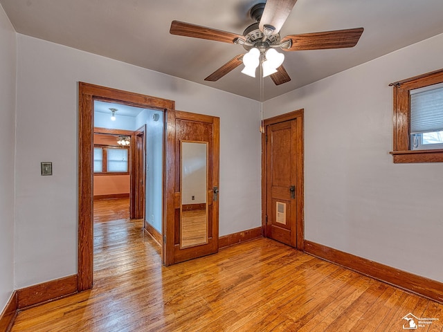 unfurnished room with ceiling fan, a healthy amount of sunlight, and light hardwood / wood-style floors