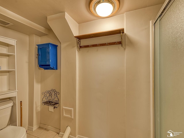 bathroom with tile patterned flooring and toilet